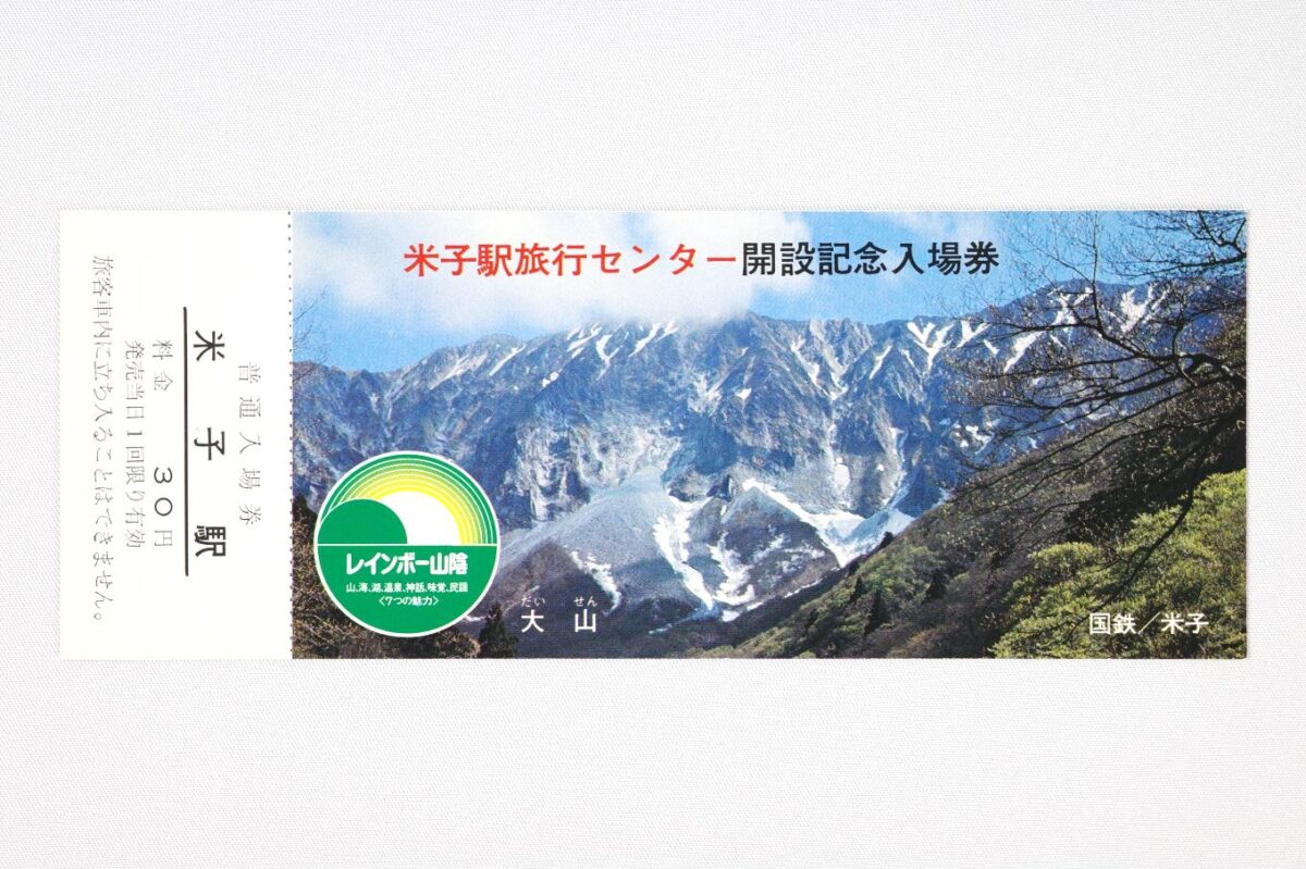 入場券の表面。全体が大山の写真で飾られている。ふもとには新緑、高いところには雪渓がある春の姿だ。写真には米子駅旅行センター開設記念入場券の文字が載せられている。サイズは15.8×6cm。